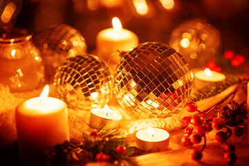 Winter Christmas holidays background with candles, christmas light, toy near a window