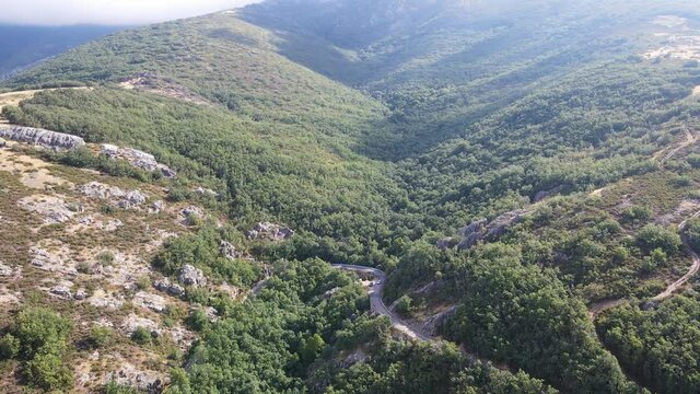 Cars driving on a winding road between mountains. Somosierra Madrid.