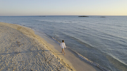Woman Walking alone on the Beach at Sunset, Aerial