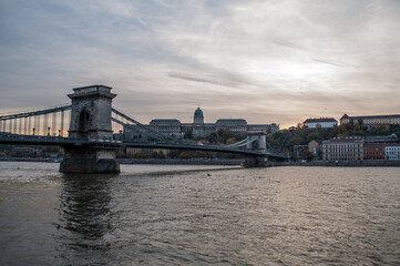 Fototapeta na wymiar The Chain Bridge in Budapest (Hungary) over the Danube River with the setting evening sun in the background