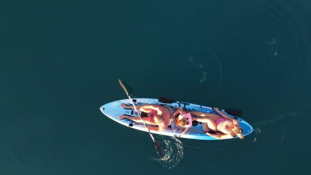 Aerial view on canoe with family. Man, woman and little children
