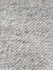 Gray carpet natural fluffy sheep wool. Fabric background with certain texture pattern. Woven texture
