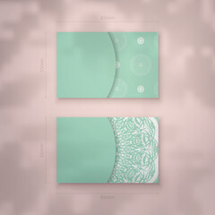 Mint color business card template with Greek white ornament for your contacts.