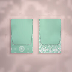 Mint color business card template with vintage white ornaments for your business.