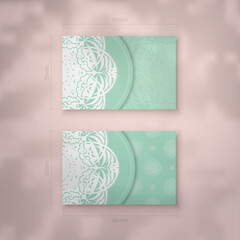 Mint color business card with Indian white pattern for your brand.