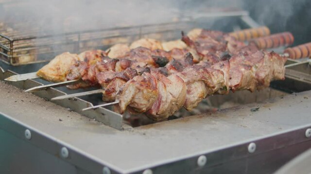 Barbecue meat roasting on skewers. Grilling pork kebab on skewers at bbq. Street food
