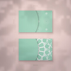 Mint colored business card with vintage white ornament for your contacts.