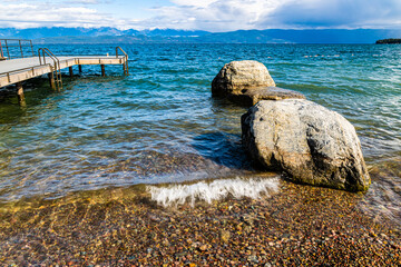 Large Boulders On The Shore of Flathead Lake With Snow Capped Mountains, Volunteer Park, Lakeside,...