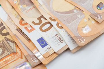 Pile of euro banknotes, finance currency isolated on dark background.  Several 50 euro banknotes....