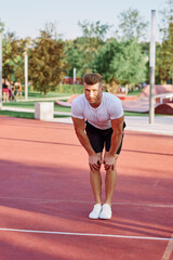 Fototapeta premium man in white t-shirt on the sports ground workout motivation