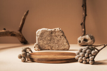 Podium wooden on beige background. Composition with stones and branches. Mock up for presentation...