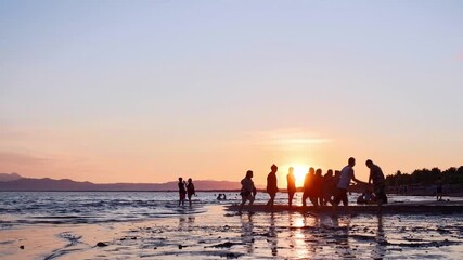 Relaxed covid-19 pandemic community and social restrictions announcement brought excitement to people that many gather their families to the beaches. Silhouettes. - Powered by Adobe