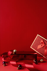 Red podium for christmas product display on red background. Product display stand. Christmas baubles decoration