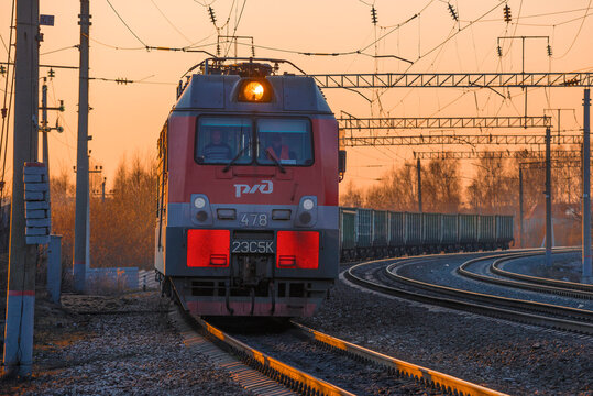 SHARYA, RUSSIA - APRIL 11, 2021: Russian electric locomotive 2ES5K of "Ermak" series with freight train on a April evening. Front view