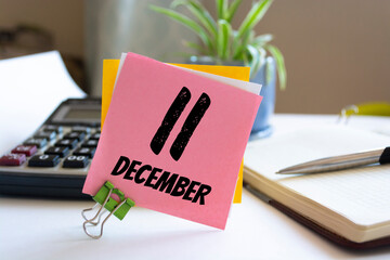 December 11th. Day 11 of month, calendar on informal workplace background. Top view. Winter time. Empty space for text