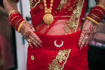 Fototapeta na wymiar Indian bride's wearing her jewellery and bangles hands close up