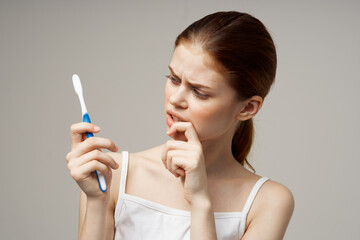 woman with a toothbrush in hand morning hygiene studio lifestyle