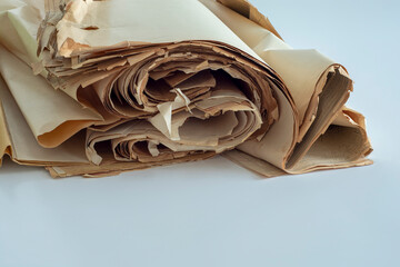 Old, randomly folded paper, as waste paper.
