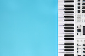 Fototapeta na wymiar Musical background with musical keys on blue, flat lay, copy space.