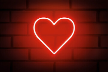 Heart shaped neon sign on brick wall