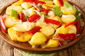 Spanish Patatas a lo Pobre Poor Man's Potatoes close up in the plate on the table. Horizontal