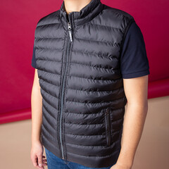 man in a black vest on the background.
