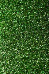 Full frame macro abstract texture background of sparkling green glitter with bokeh