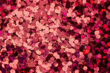Full frame macro abstract texture background of sparkling red glitter with bokeh