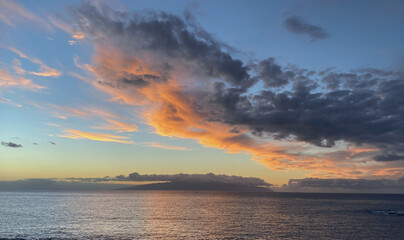 Beautiful sunset over the ocean with dramatic clouds and sky