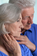 Portrait of sad senior couple posing at home
