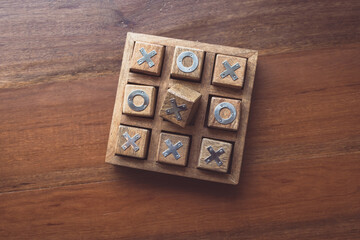 Vintage Tic Tac Toe wooden board game on wooden top table