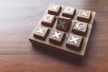 Vintage Tic Tac Toe wooden board game on wooden top table