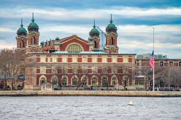 Ellis Island building exterior, view from moving boat in New Yor