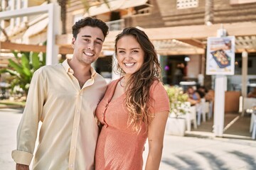 Man and woman couple smiling confident and hugging each other at street