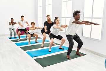 Fototapeta premium Group of young people concentrate training legs exercise at sport center.