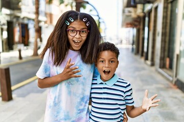 African american family of bother and sister standing at the street celebrating victory with happy smile and winner expression with raised hands