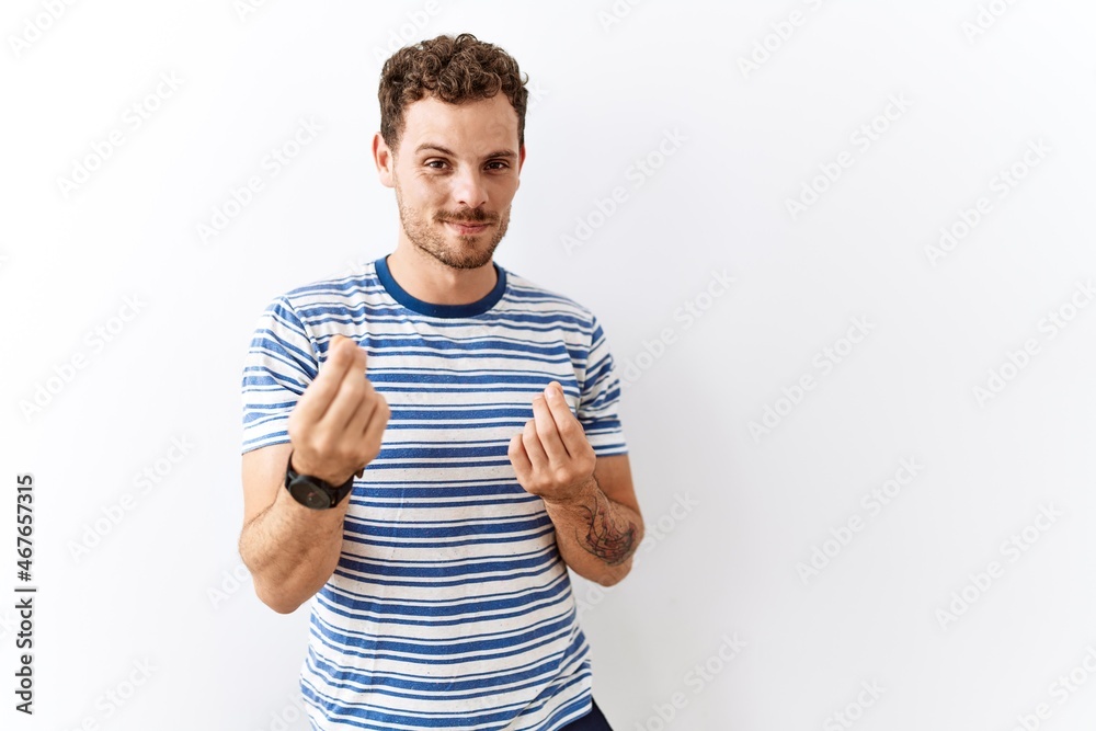 Poster Handsome young man standing over isolated background doing money gesture with hands, asking for salary payment, millionaire business