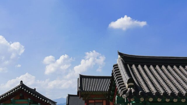 Peaceful clouds passing over the roof of traditional Korean hanok architecture in South Korea