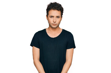 Young handsome man wearing casual black t shirt depressed and worry for distress, crying angry and afraid. sad expression.