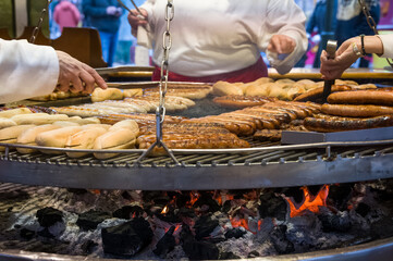 Large bratwurst sausage grill, typical fast food on the street at a German traveling fun fair and...