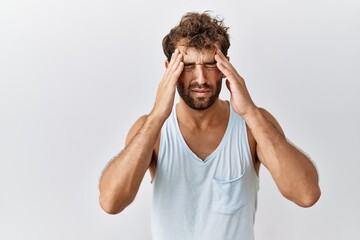 Young handsome man standing over isolated background with hand on head for pain in head because stress. suffering migraine.