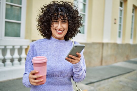 Young middle east woman smiling confident using smartphone at street