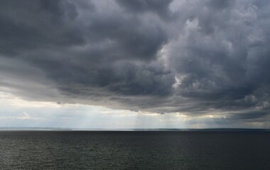 Rainy dark clouds over the river