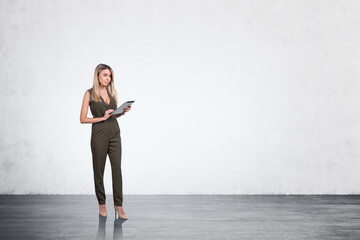 Businesswoman in jumpsuit with table in hands working, mockup