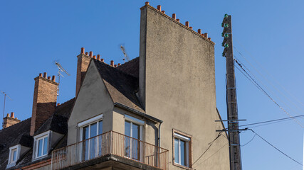 French style house with tall multi pot chimney