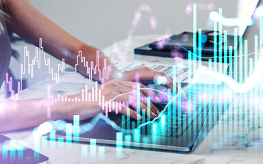 Close up businesswoman hand is typing laptop keyboard to continue trading operations. Concept of analyzing stock market behavior. Forex candlestick bar graphs.