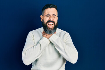 Young hispanic man wearing casual clothes shouting and suffocate because painful strangle. health problem. asphyxiate and suicide concept.