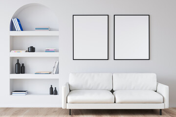 Two canvases on white wall of living room with arched niche shelf