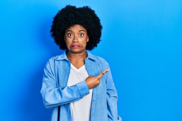 Young african american woman wearing casual clothes pointing aside worried and nervous with forefinger, concerned and surprised expression