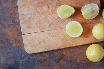 Lemon slices and lemon fruit  on wooden cutting board